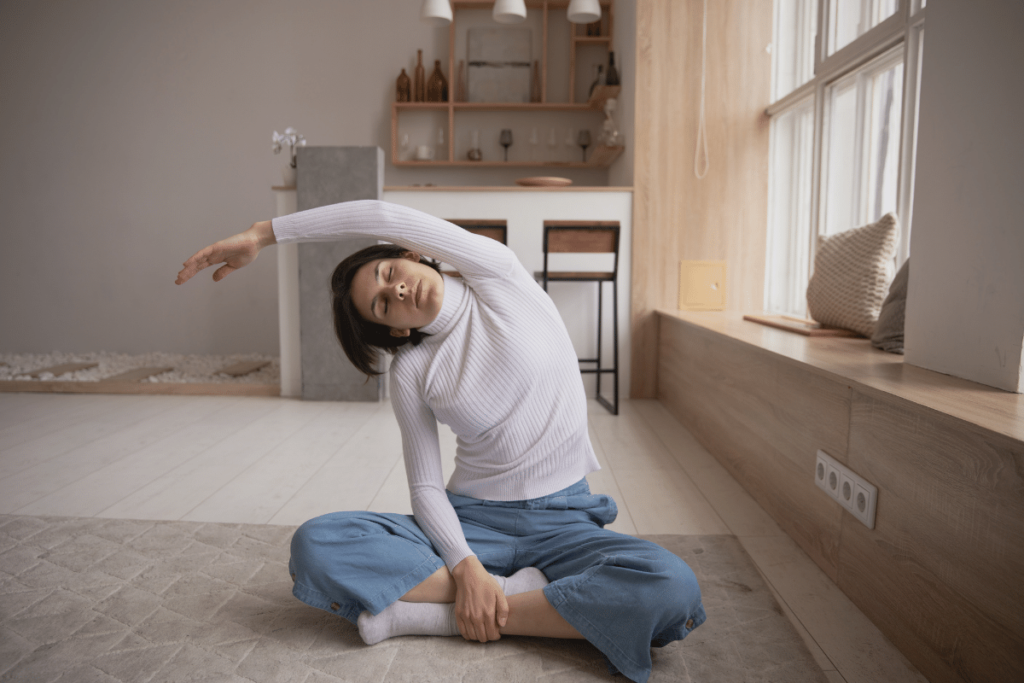 taking breaks while working from home to increase productivity. woman stretching